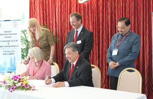 Susan Moore (CEO of STC Consortium Ltd) and Tunku Dato Seri Iskandar Abdullah (Group Executive Chairman of Melewar Group Berhad) sign the collaborative agreement at the British High Commissioner's Residence. Looking on are Pam Sutton (COO of STC Consortiu