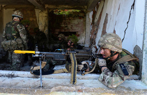 A Royal Marine gunner keeps a watchful eye out for the enemy during the assault on Sazan Island [Picture: Petty Officer (Photographer) Sean Clee, Crown copyright]