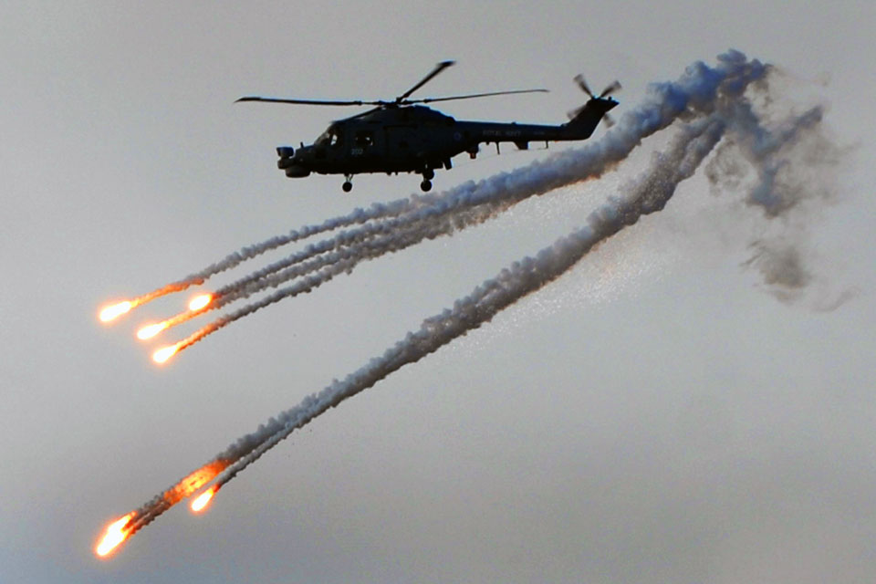 A Lynx helicopter deploys counter-heat-seeking-missile flares