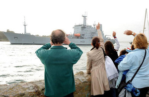 A crowd waves from Devil's Point as HMS Scott leaves Devonport Naval Base