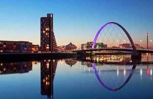 Glasgow city scene with reflection of the Clyde Arc Bridge at dusk.