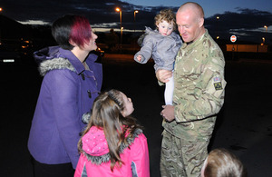 Sapper Ciaran Tannay is reunited with his family at Perham Down [Picture: Shane Wilkinson, Crown Copyright/MOD 2012]
