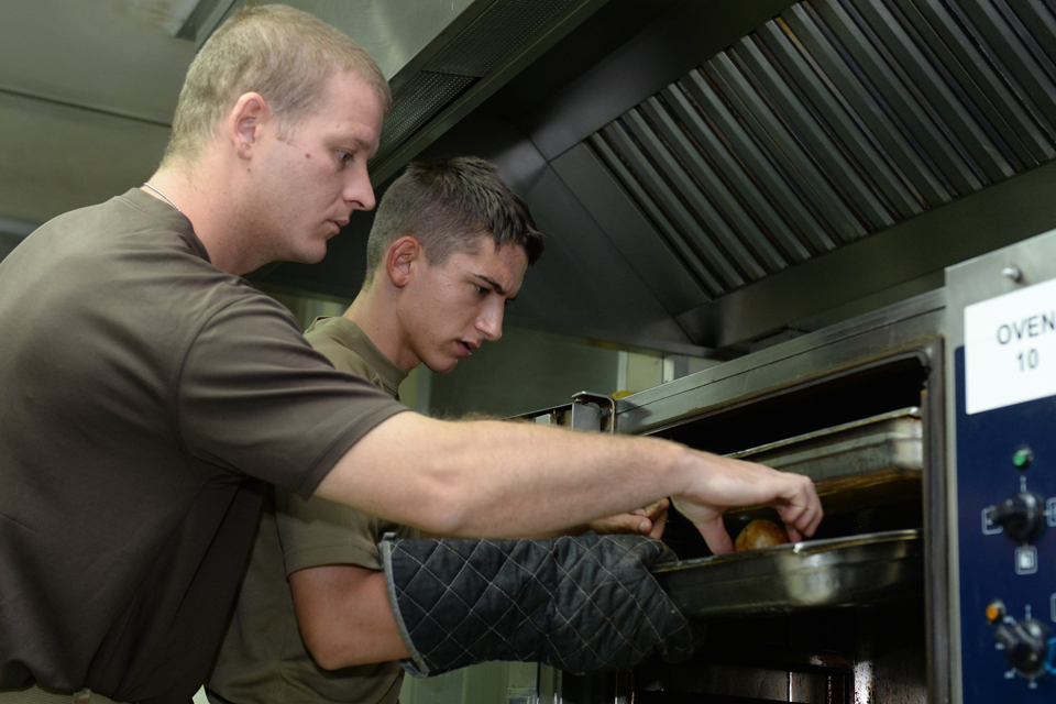 Army chef cooks under instruction