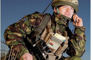 A soldier using a headset to communicate with his colleagues