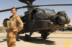 Army Air Corps Pilot Captain Joanna Gordon in front of an Apache attack helicopter