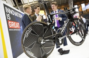 University of Sheffield's Sam Turner and James Hunt talk to Rt Hon Greg Clark MP, with the Team Sky bike at Innovate 2016, Manchester Central Conference Centre.