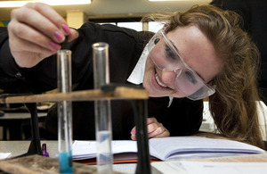 Female science student looking at test tubes in a laboratory