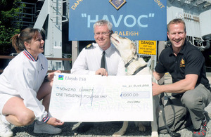 Personnel at HMS Raleigh with the cheque for the Nowzad Dogs charity