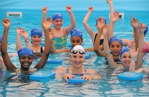 Rebecca Adlington in swimming pool with young people at a Pools 4 Schools event