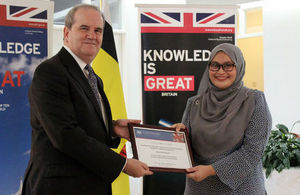 British High Commissioner David Campbell presenting Siti Nurfateha Abdullah with a certificate