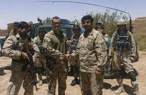 Major Adam Wolfe shakes hands with the new Commander of Patrol Base Silab, Lieutenant Haji Zainoulla
