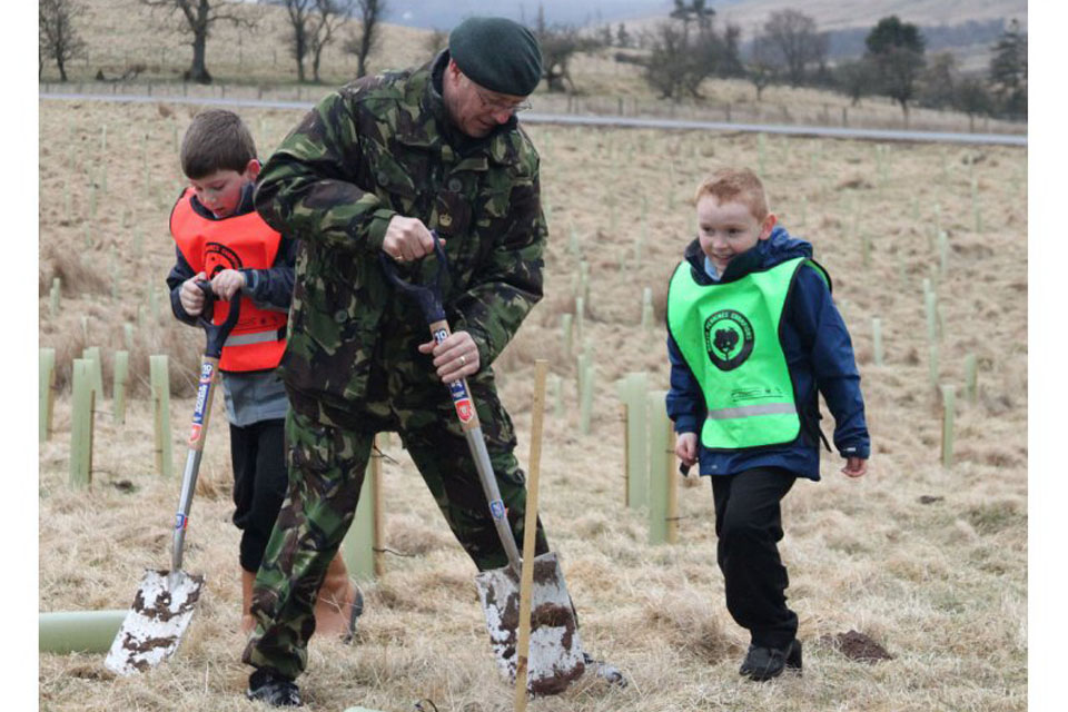 Major Tam Campbell (Ret'd) and volunteers plant trees at Defence Training Estate (DTE) Warcop