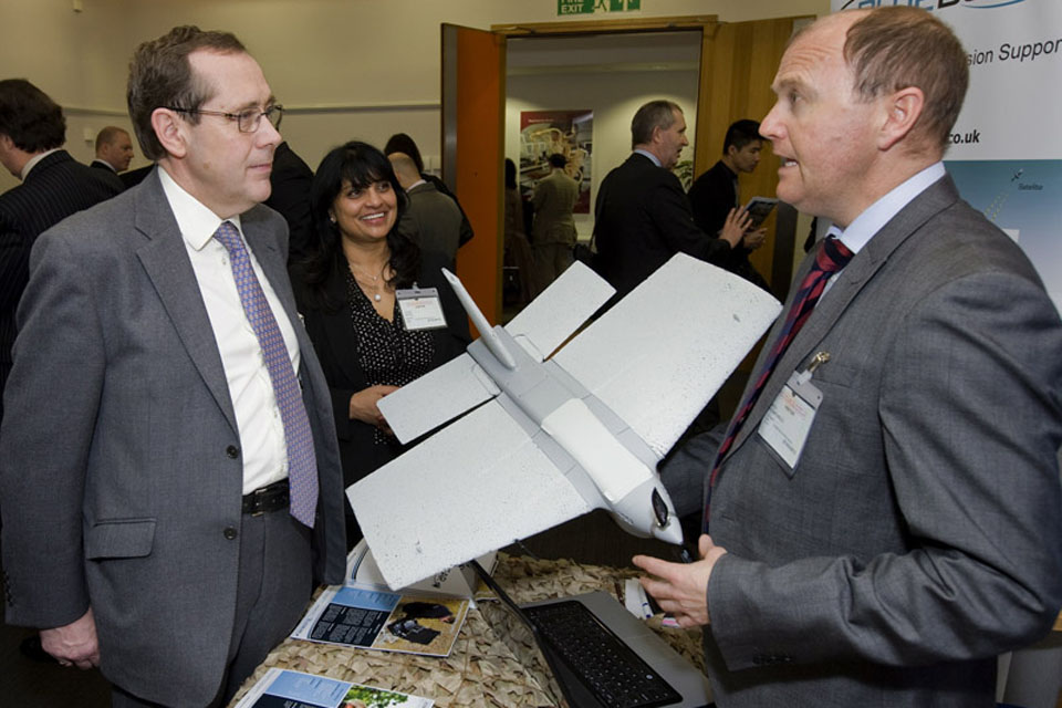 Minister for Defence Equipment, Support and Technology Peter Luff talks to a representative from Blue Bear Systems Research, who have developed a lightweight unmanned air vehicle system 