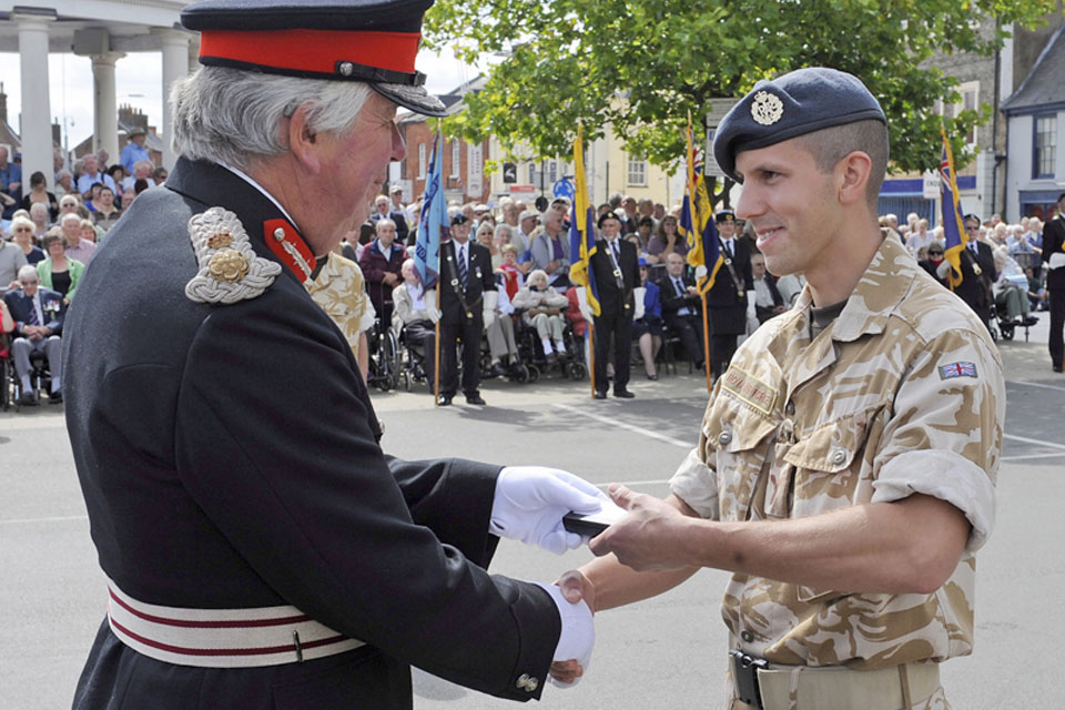 Richard Jewson, the Lord-Lieutenant of Norfolk, presents a member of II (Army Cooperation) Squadron with his Operational Service Medal  