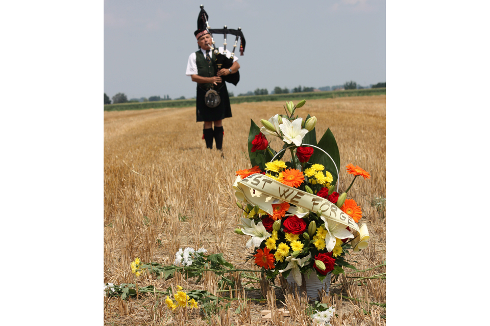 A lone piper plays a lament at the crash site of Boston BZ590