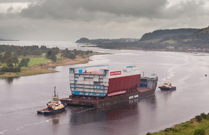 The mid-section of what will be HMS Queen Elizabeth's hull being transported down the Clyde from BAE Systems' shipyard in Govan, Glasgow