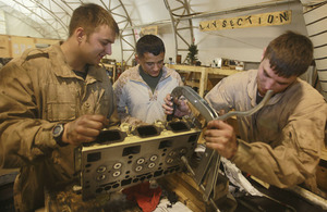 From left: Craftsman Adam Evans, Corporal Lorenzo Arebalos and Lance Corporal Craig Heaton repair an automotive component at the Intermediate Maintenance Activity lot in Camp Leatherneck