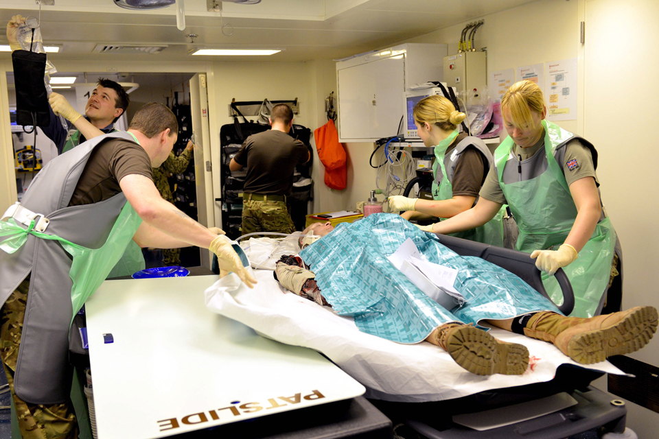 The medical team get ready to prep a casualty for an operation