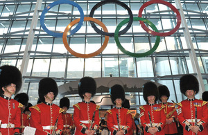 Bandsmen and women from the Band of the Irish Guards beneath the newly-unveiled Olympic Rings at London Heathrow's Terminal 5