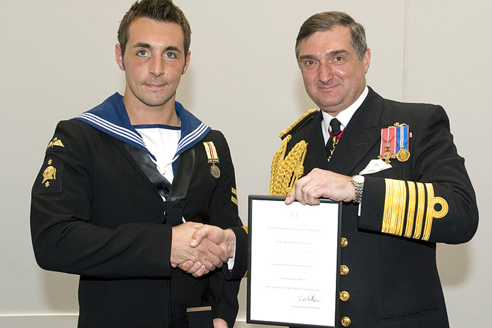 Admiral Sir Trevor Soar (right) presents the Queen's Commendation for Bravery to Leading Seaman (Diver) Carl Thomas
