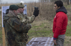 A demonstration of joint working between International Security Assistance Force and Afghan National Security Forces troops as a potential new recruit to the Afghan police is photographed and finger printed before his training programme starts [Picture: A