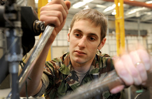 Corporal Mike Lacchin working on an Apache helicopter at Wattisham Flying Station in Suffolk