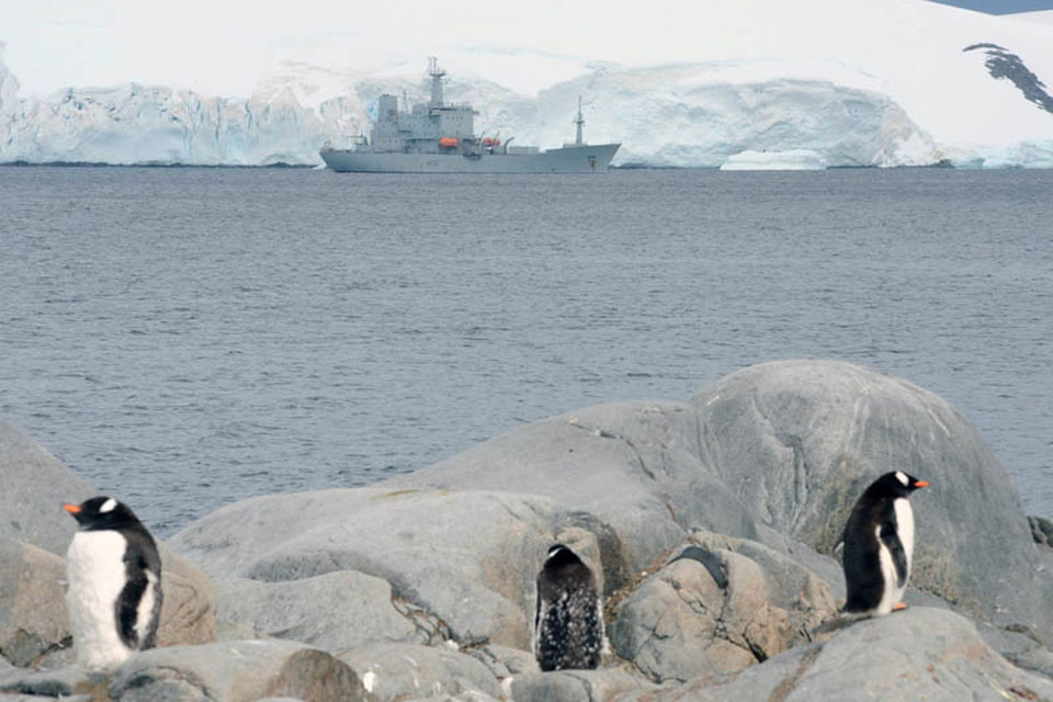 Penguins stand sentry as HMS Scott visits Port Lockroy during her last Antarctic deployment 