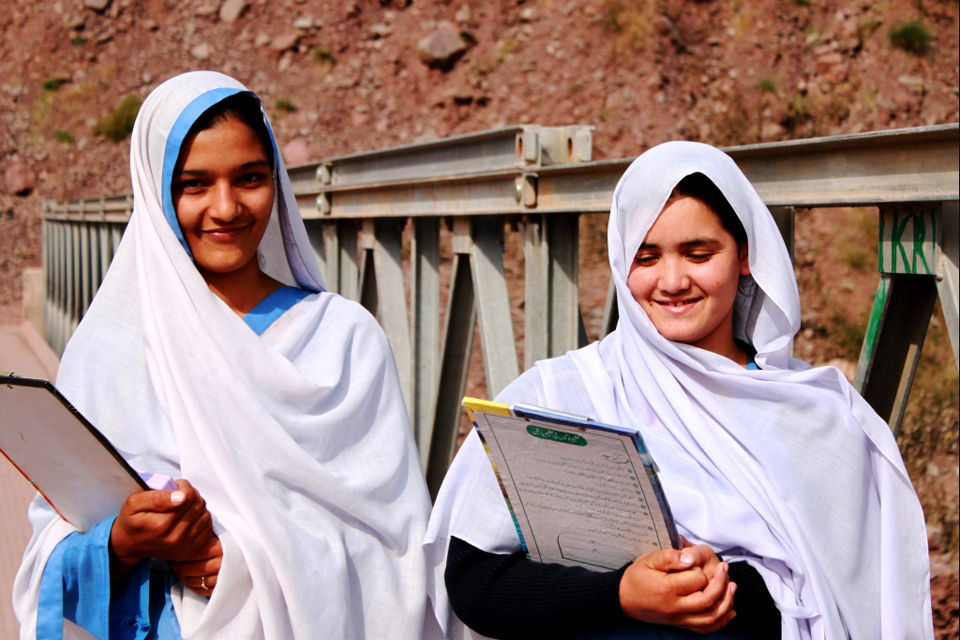 Students Andleed (left) and Nusrat (right) use a new bridge built with british support to get to school every day. Picture: Victoria Francis/DFID