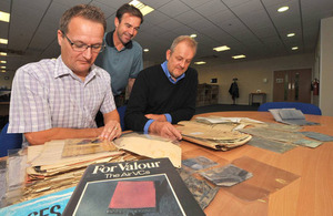 Record reviewers (from left to right) Grant Hodgkins, Stephen Searle and Carl Basson with some Second World War RAF casualty packs [Picture: Petty Officer Airman (Photographer) Owen Cooban, Crown copyright]