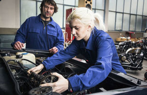 Apprentice mechanic working on a car engine