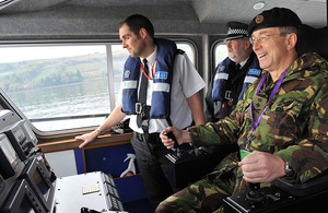 General Sir David Richards takes the controls of a patrol vessel