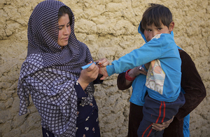 A polio immunisation worker marks the finger of a child with indelible ink as a sign that he has been vaccinated during a national immunisation campaign supported by UK aid. Picture: WHO