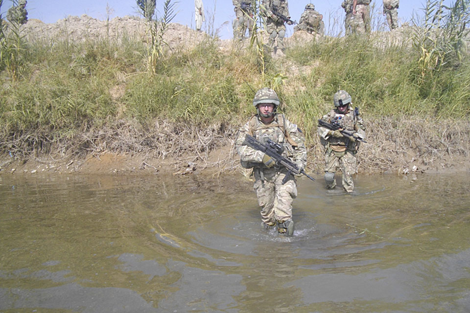 Soldiers from C Company, 1st Battalion The Princess of Wales's Royal Regiment, wade into a river during Operation TORA GHAR