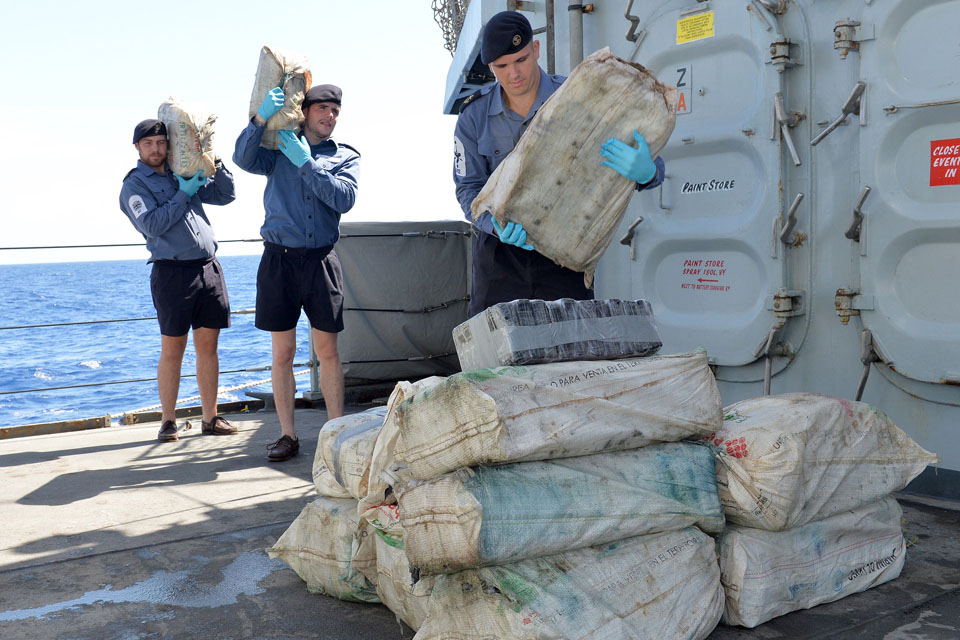 Royal Navy sailors transferring the seized cocaine to a US Coast Guard vessel