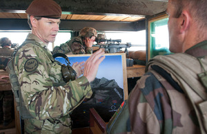 Lieutenant General Adrian Bradshaw talks about security in Tagab Valley with a French Army serviceman, in a guard tower at Forward Operating Base Tagab, Afghanistan