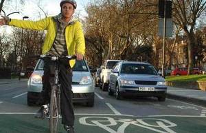 Person signalling on bicycle.