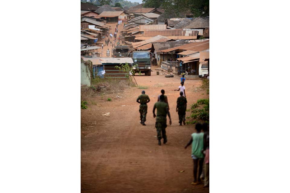 The military engineers drive through a town in Sierra Leone