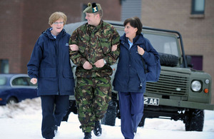Corporal Joe Mearns gives a helping hand to Community Staff Nurses Margaret McLoskey (right) and Rosemary Robertson
