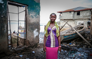 Celina Kamanda stands near the water's edge in Magazine Wharf - one of Freetown's largest slums, where families were hit hard by the Ebola outbreak. Picture: Simon Davis/DFID