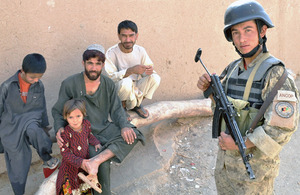 An Afghan National Civil Order Police officer with villagers