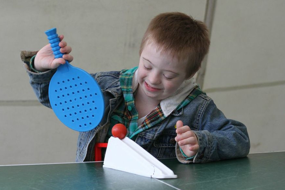 A child about to serve in table tennis