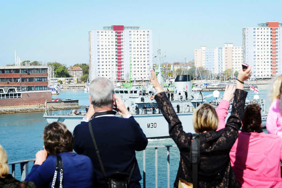 Families and friends wave to loved ones