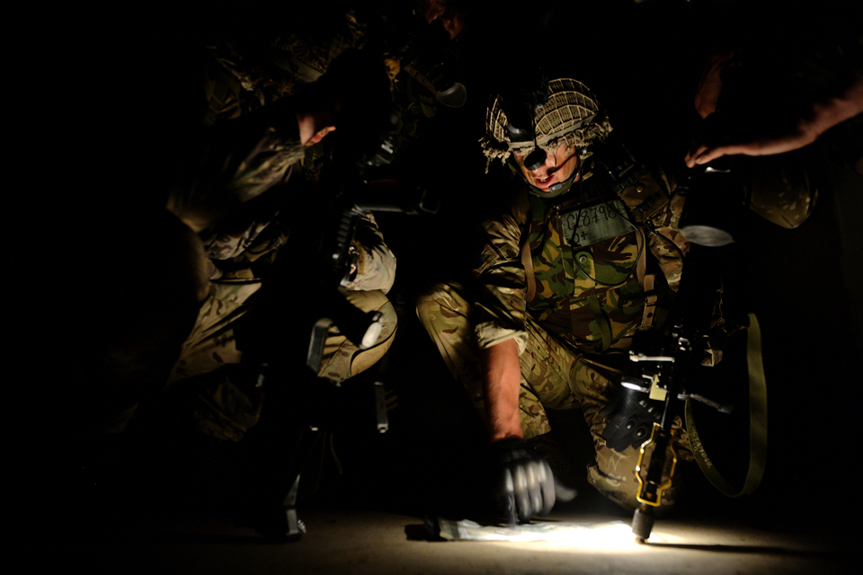 Lieutenant Tom Glinn briefs his men during a night operation