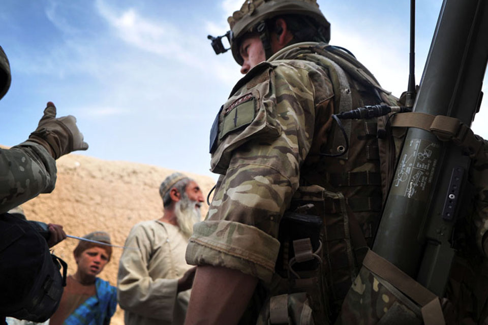 Soldiers from 1st Battalion The Rifles speak with villagers following their helicopter insertion into the town of Alikosi in Helmand province