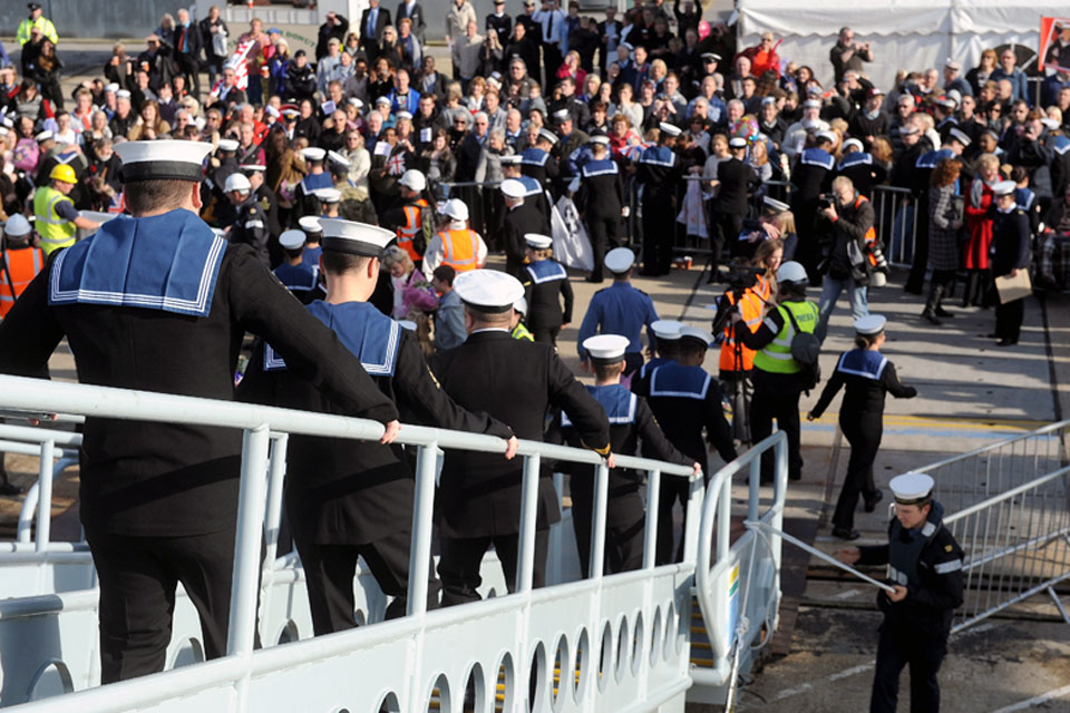Sailors descend the gangway from HMS Dauntless onto dry land at Portsmouth