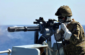 A sailor onboard HMS Sutherland conducts live firing off Gibraltar