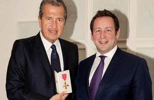 Photographer Mario Testino being presented with an honorary OBE by Culture Minister Edward Vaizey