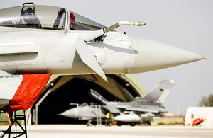 An RAF Typhoon aircraft, with a Tornado GR4 in the background, is prepared for a mission at Gioia del Colle air base