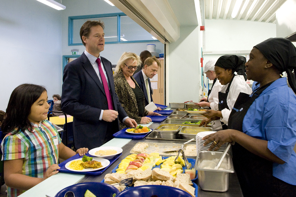 Deputy Prime Minister Nick Clegg eating lunch with students from Walnut Tree Walk Primary School.