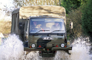 A military truck makes its way through flood water